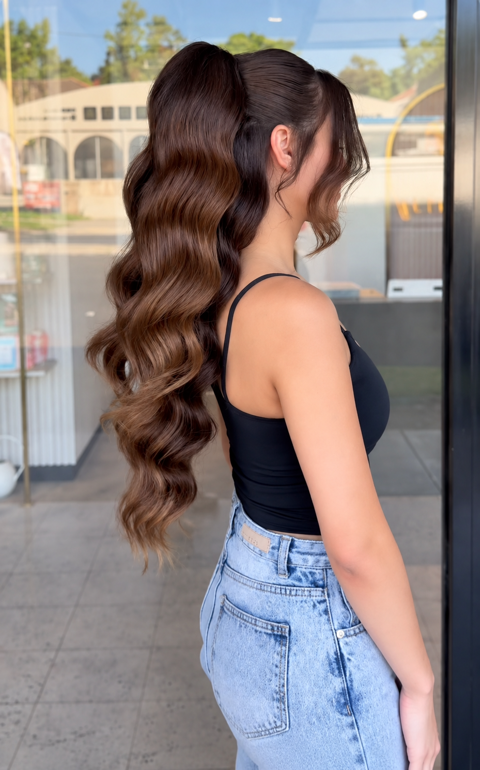 Long glossy brunette waves viewed from behind
